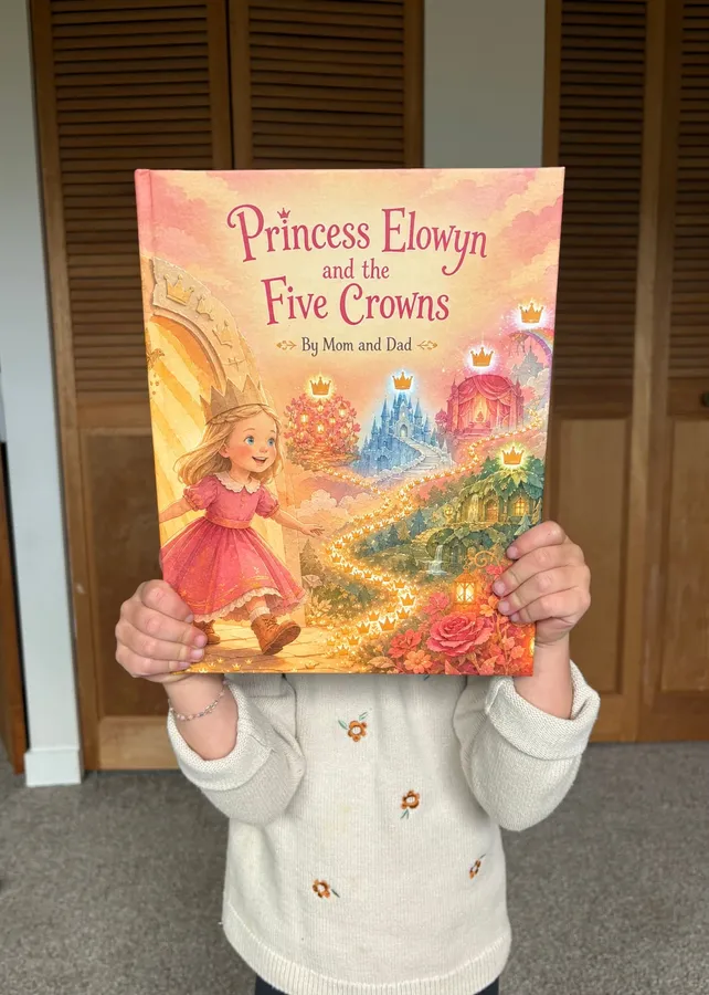A child smiling while holding her personalized Sundayfawn storybook