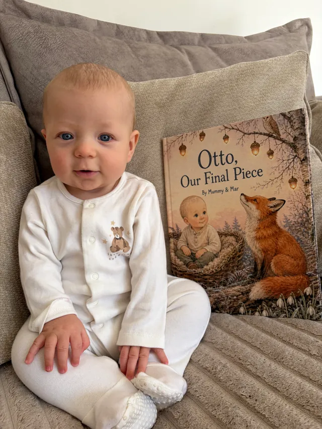 Otto sitting beside his printed Otto, Our Final Piece storybook