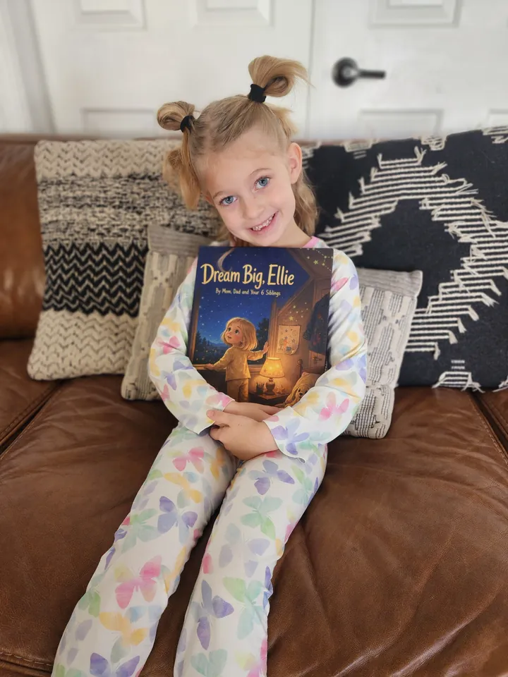 Ellie holding her printed Dream Big, Ellie storybook