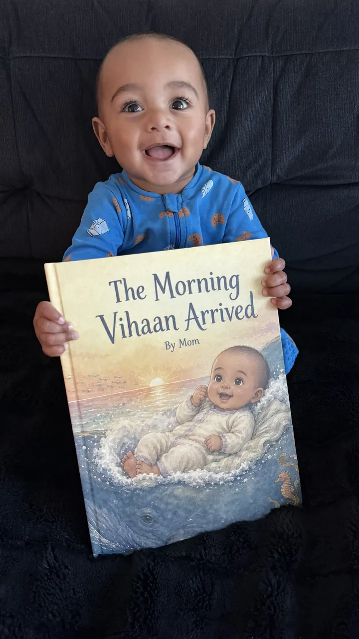Vihaan holding his personalized birth story, The Morning Vihaan Arrived