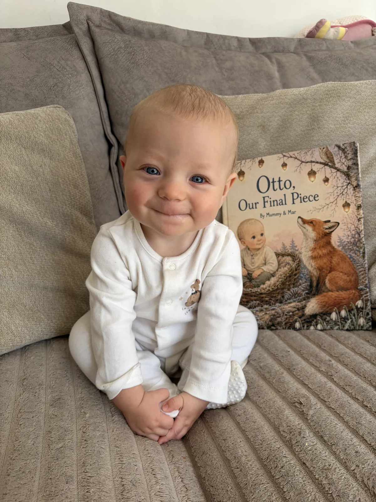 Otto smiling beside his personalized Sundayfawn hardcover.