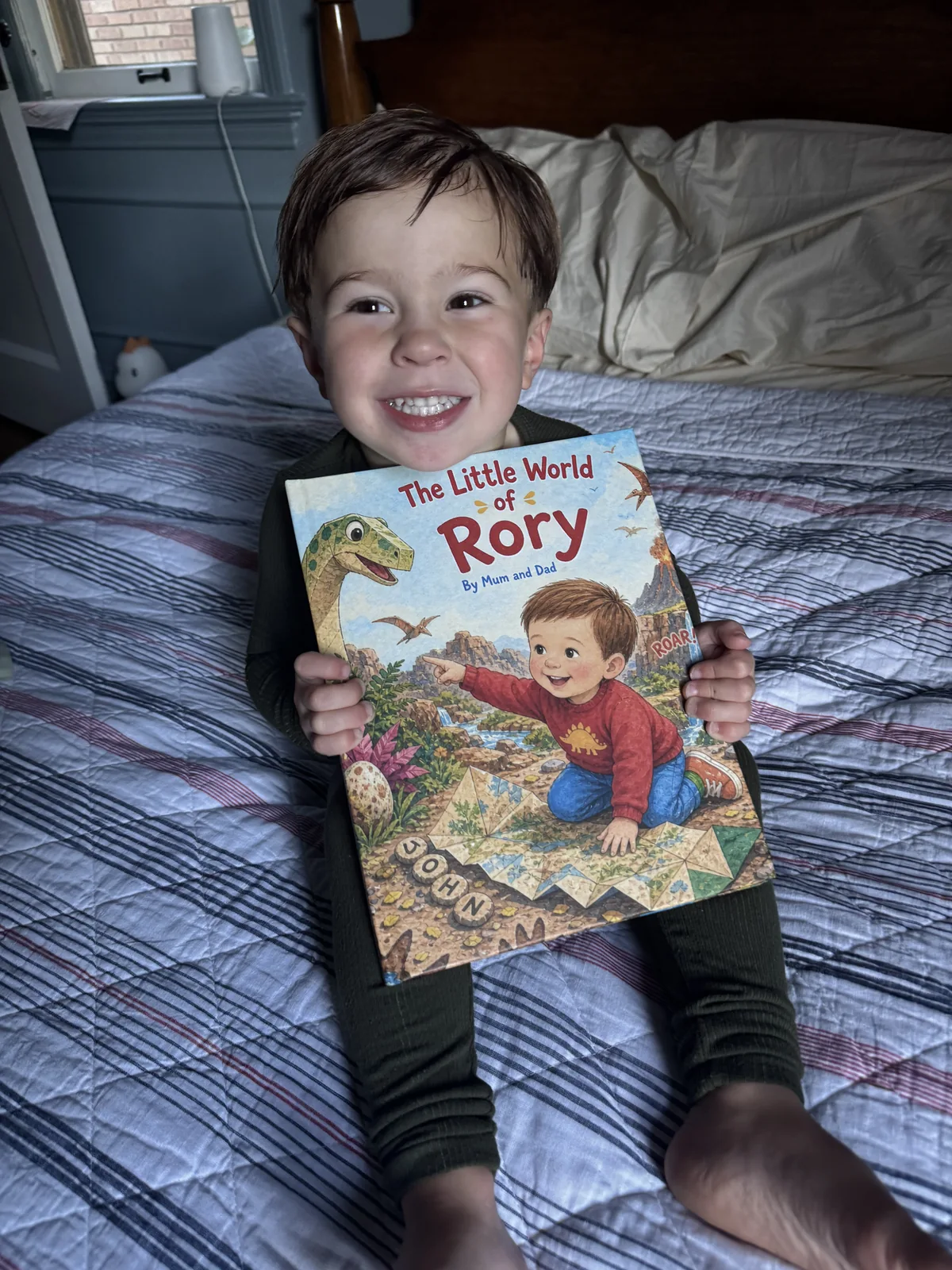 Rory smiling with The Little World of Rory hardcover.