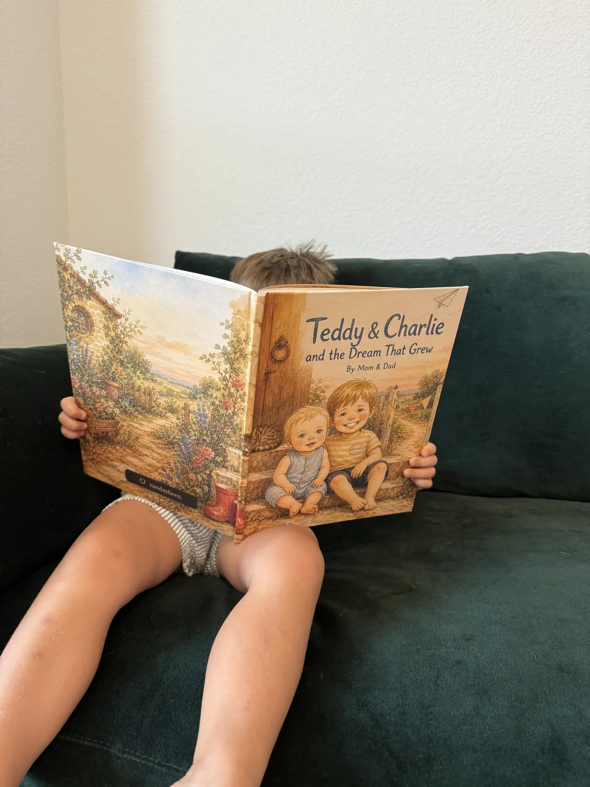 A child holding Teddy & Charlie and the Dream That Grew, a personalized sibling storybook.